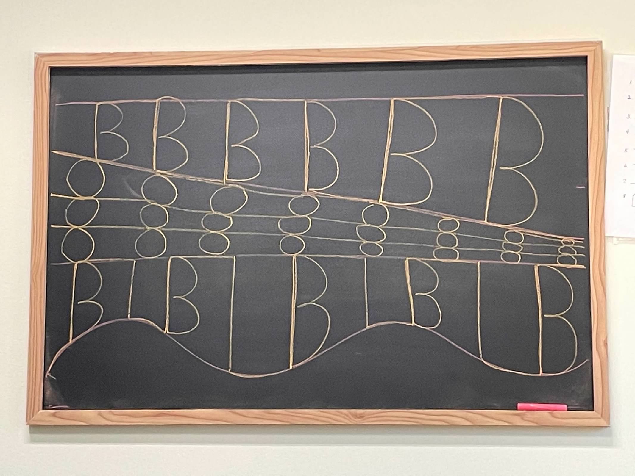 Framed chalkboard with B letter practice